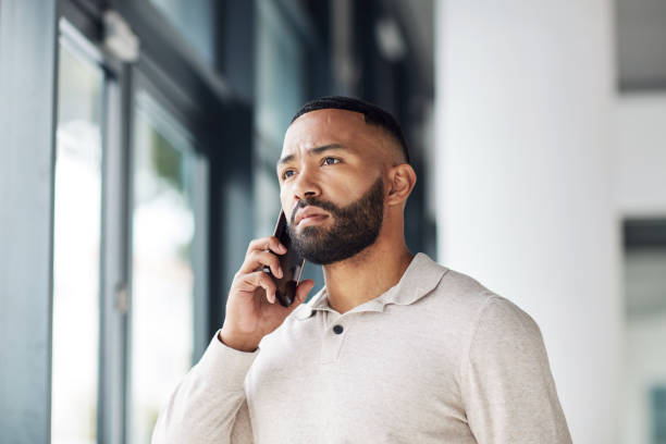 Thinking, serious and businessman talking on a phone call for networking, communication and idea. Listening, focus and employee with a mobile for conversation, discussion and connection at work